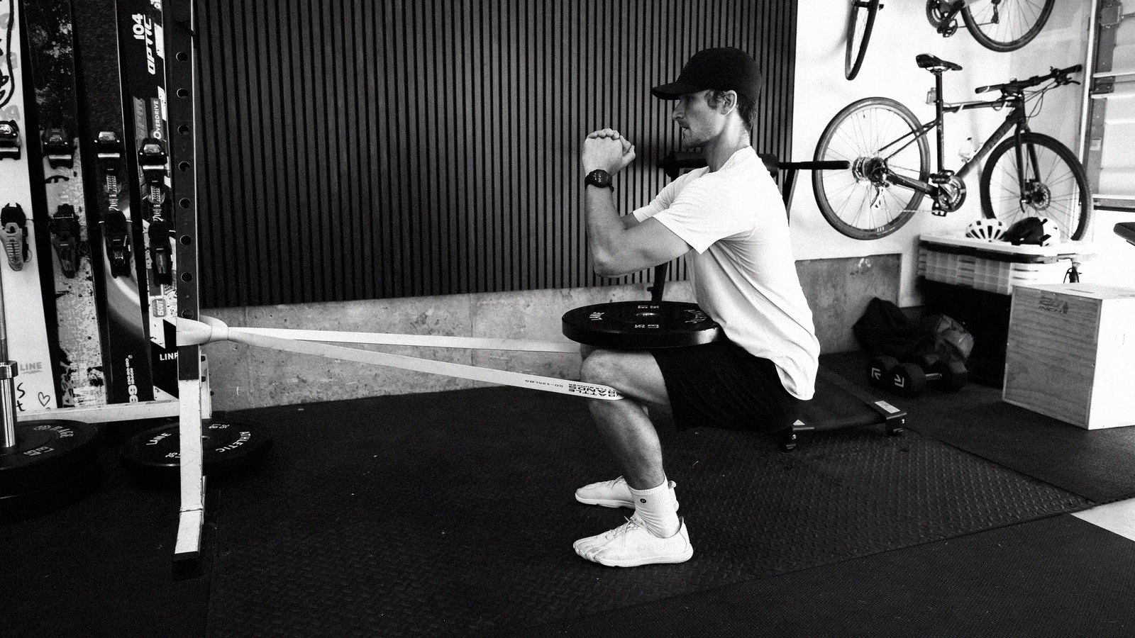 Connor doing banded knee work in his garage gym