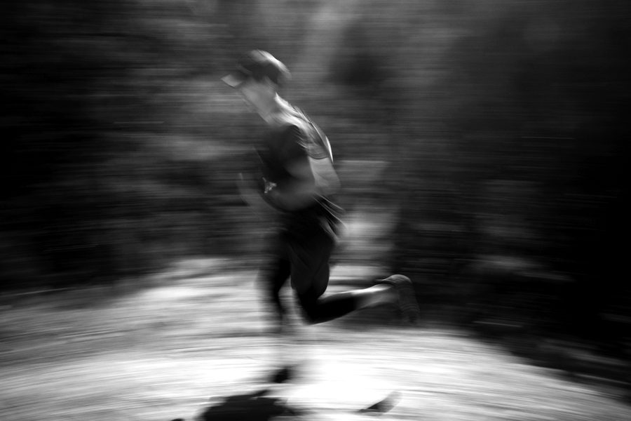 Connor trail running on red dirt, panned motion blur