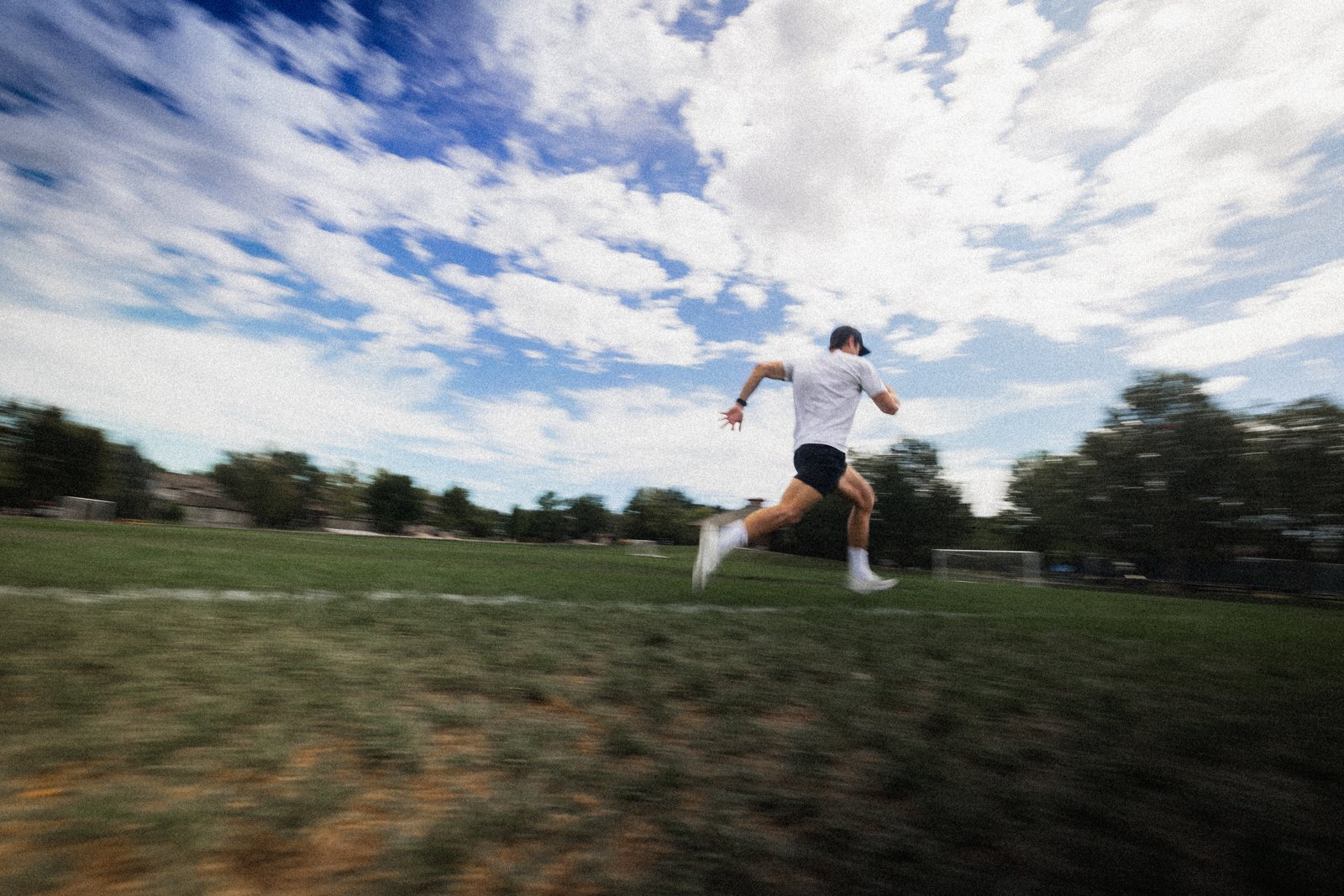 Connor running on a field, panned motion blur