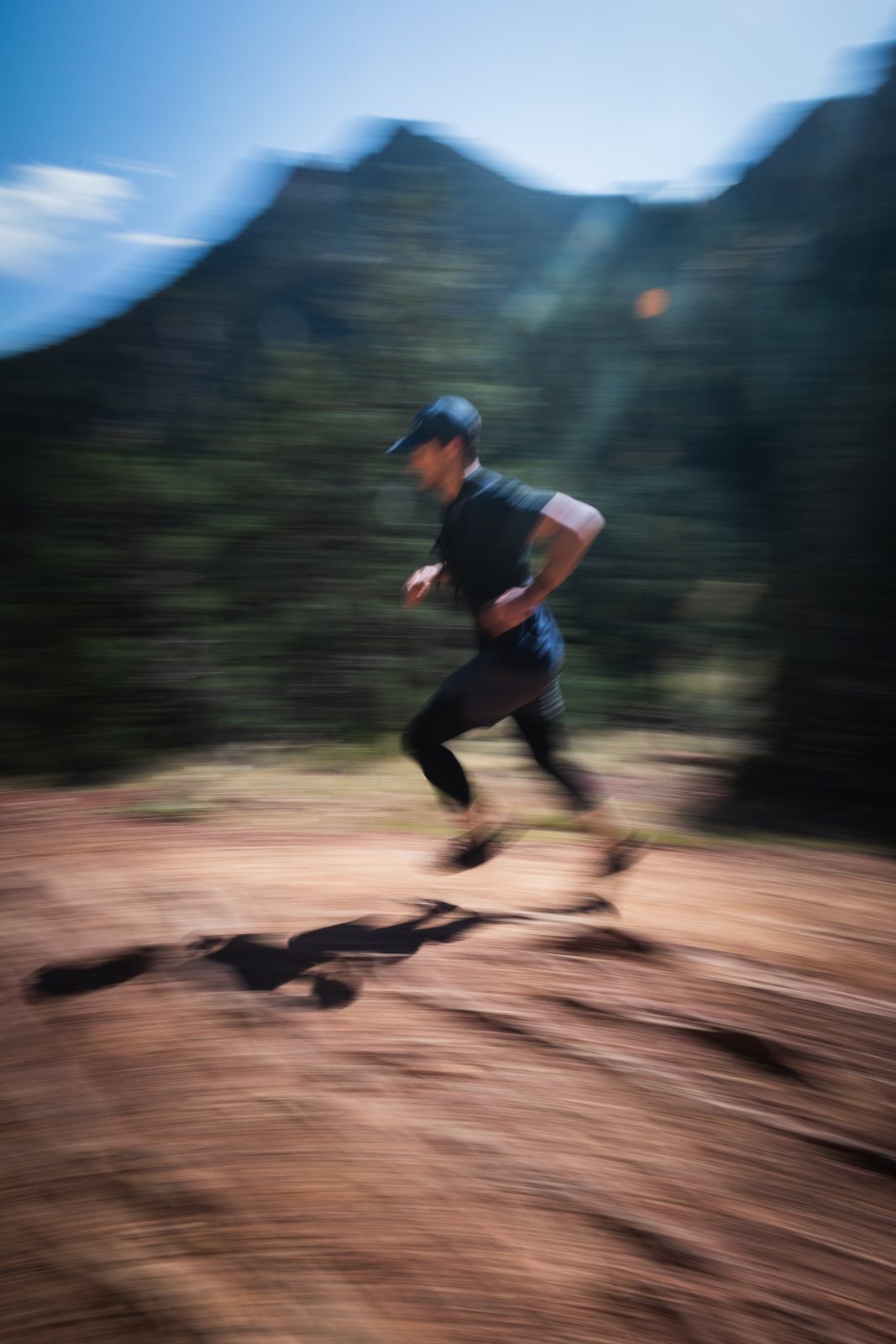 Connor trail running on red dirt: Kneehab Run, the return-to-running program