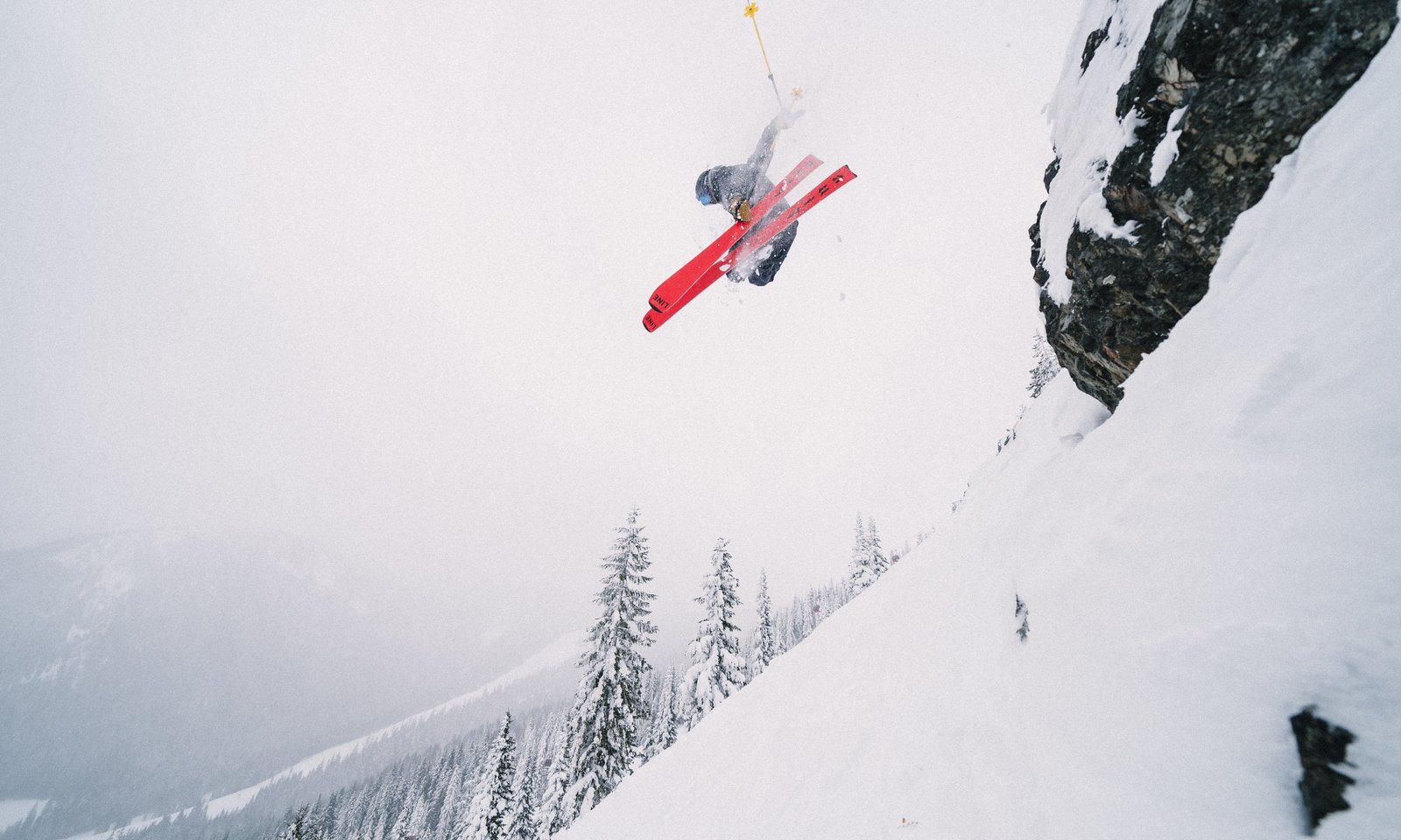 Connor flipping off a cliff into powder